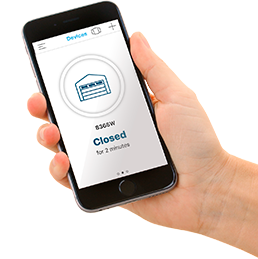 Hand of a person holding a cell phone with the myQ application