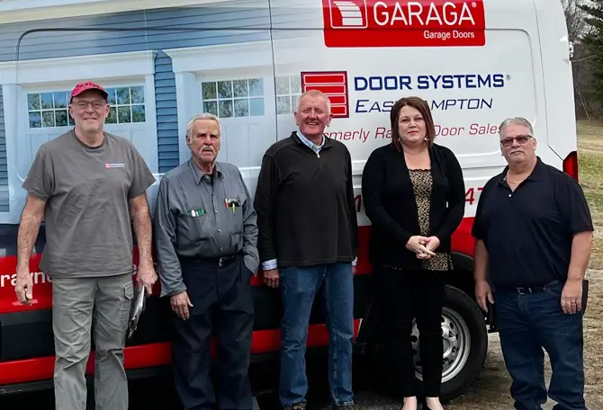 Door Systems Easthampton technicians in front of a truck services