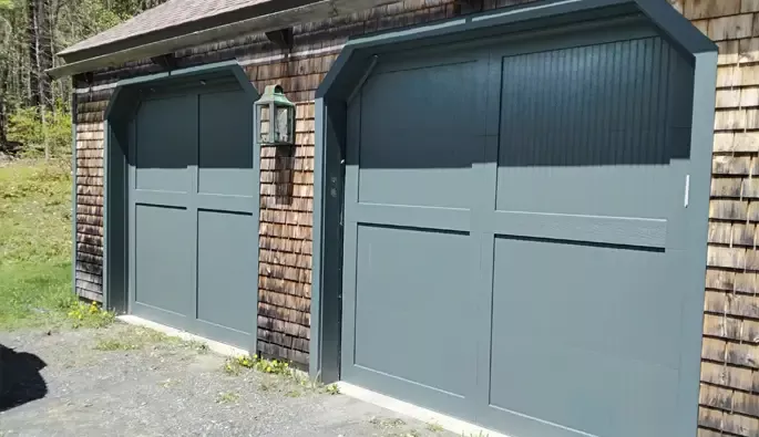 Two garage doors in a wooden garage.