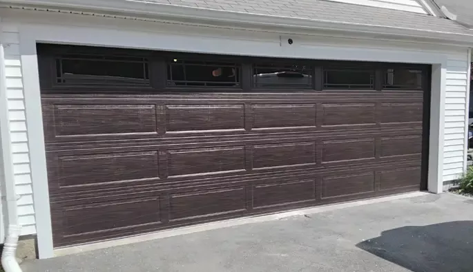 A garage door featuring brown wooden panels, showcasing a classic and natural design.