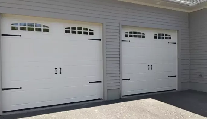 Two garage doors featuring contrasting black and white trim.